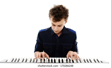 Studio Shot Of Teenager Playing An Electronic Piano, Isolated Over White Background