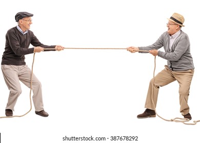 Studio Shot Of Two Cheerful Seniors Competing In A Tug Of War Isolated On White Background