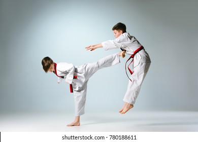 Studio shot of two of kids training karate martial arts