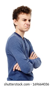 Studio Shot Of Upset Teenager With Arms Folded, Isolated Over White Background