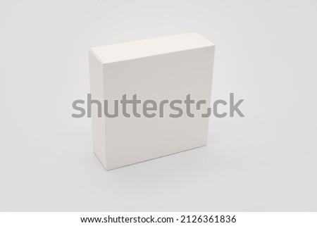 Studio Shot of Vertical White Box Isolated on Seamless White Backdrop. A high-resolution image featuring a plain white box standing upright against a seamless white backdrop.