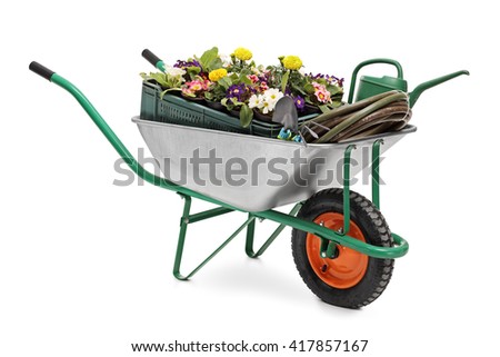 Studio shot of a wheelbarrow full of gardening equipment and flowers isolated on white background