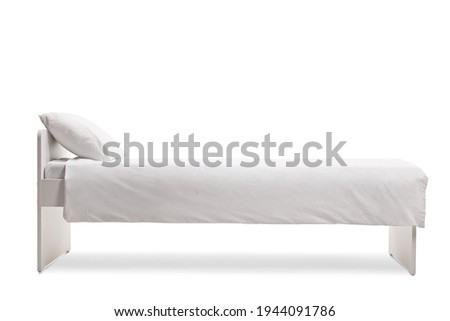 Studio shot of a white single bed with a cotton duvet cover isolated on white background