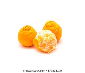 Studio Shot Whole And Peeled Large Ripe Sumo Oranges Isolated On White. A Cross Between Mandarin And California Navel Orange, Developed In Japan And Now Grown On Family Farms In San Joaquin Valley.