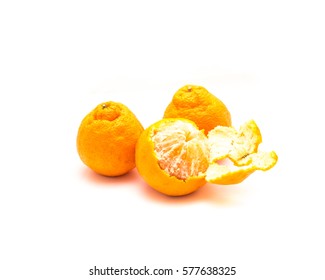 Studio Shot Whole And Peeled Large Ripe Sumo Oranges Isolated On White. A Cross Between Mandarin And California Navel Orange, Developed In Japan And Now Grown On Family Farms In San Joaquin Valley.