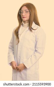 Studio Shot Of Woman With Red Hair Against Plain Background