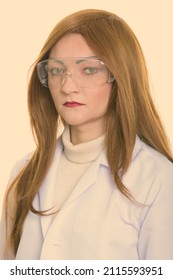 Studio Shot Of Woman With Red Hair Against Plain Background