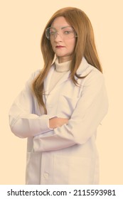 Studio Shot Of Woman With Red Hair Against Plain Background