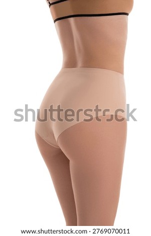 Studio shot of a woman's shapely lower back, hips, and buttocks in nude underwear. Minimalist composition on a clean white background. Perfect for beauty, body care, or lingerie concepts