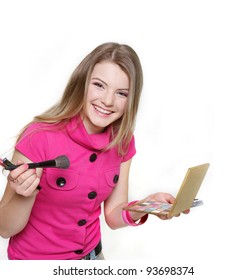 studio shot of young attractive woman doing make up