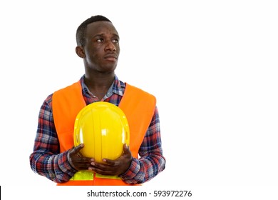 Studio Shot Of Young Black African Man Construction Worker Thinking While Looking Up And Holding Hard Hat