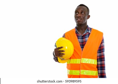 Studio Shot Of Young Black African Man Construction Worker Thinking While Holding Safety Helmet