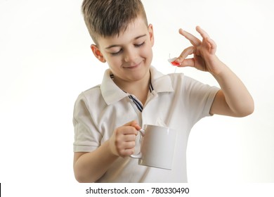 Studio Shot Of Young Boy Making Cup Of Tea - Healthy Eating Habits Concept