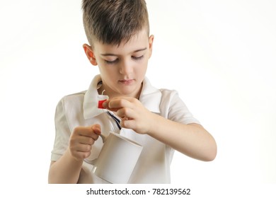 Studio Shot Of Young Boy Making Cup Of Tea - Healthy Eating Habits Concept