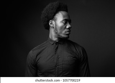 Studio Shot Of Young Handsome African Businessman Against Gray Background In Black And White