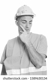 Studio Shot Of Young Handsome Man Construction Worker Thinking