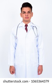 Studio shot of young handsome multi-ethnic man doctor against white background