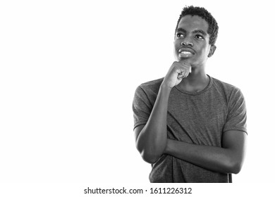 Studio Shot Of Young Happy Black African Teenage Boy Smiling And Thinking While Looking Up