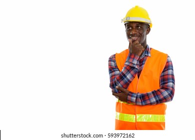 Studio Shot Of Young Happy Black African Man Construction Worker Smiling And Thinking While Looking Up