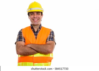 Studio Shot Of Young Happy Persian Man Construction Worker Smiling With Arms Crossed