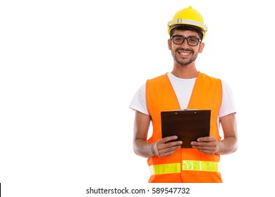 Studio Shot Of Young Happy Persian Man Construction Worker Smiling While Holding Clipboard