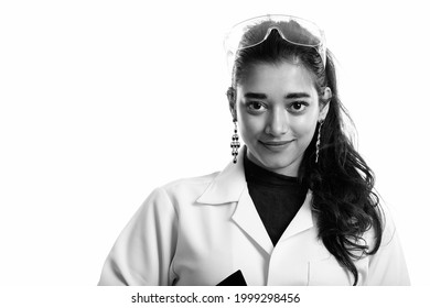 Studio Shot Of Young Indian Woman Doctor With Protective Glasses Isolated Against White Background In Black And White