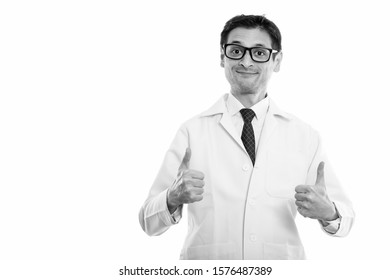 Studio shot of young man doctor giving thumbs up