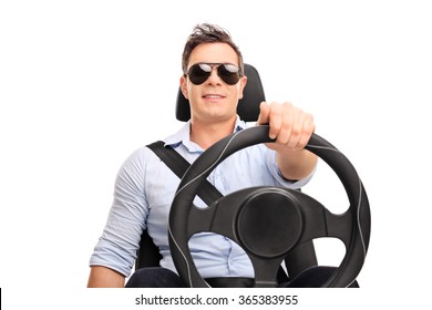 Studio Shot Of A Young Man Holding A Steering Wheel And Pretending To Drive Isolated On White Background