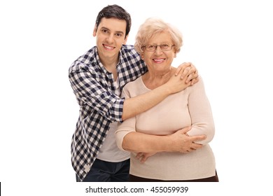 Studio shot of a young man hugging a senior lady isolated on white background