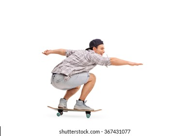 Studio Shot Of A Young Man Riding A Skateboard Isolated On White Background