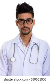 Studio shot of young Persian man doctor wearing eyeglasses