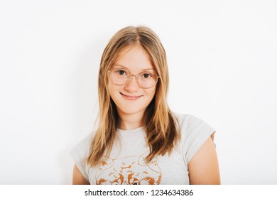 Studio Shot Of Young Preteen 10-12 Year Old Girl Wearing Round Eyeglasses, White Background