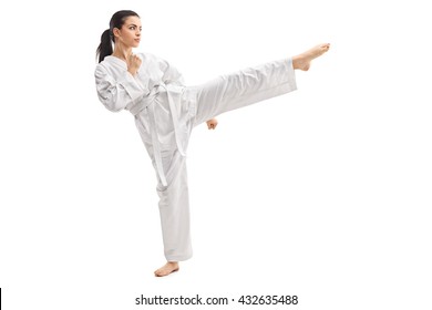 Studio shot of a young woman practicing martial arts in white kimono isolated on white background - Powered by Shutterstock