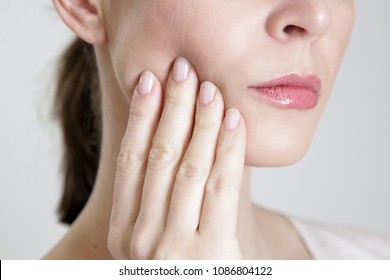 Studio Shot Of Young Woman With Tooth Pain, Close Up 