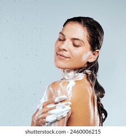 Studio, shower or calm girl washing for skincare, body hygiene or cleaning with soap. Water, white background or wet woman with wellness or foam for beauty, grooming or cleansing for morning routine - Powered by Shutterstock