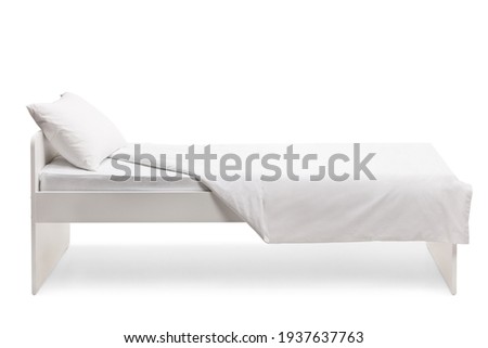 Studio side shot of a white single bed isolated on white background