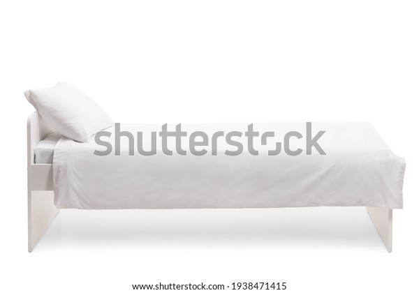 Studio side shot of a white single bed with\
duvet isolated on white\
background