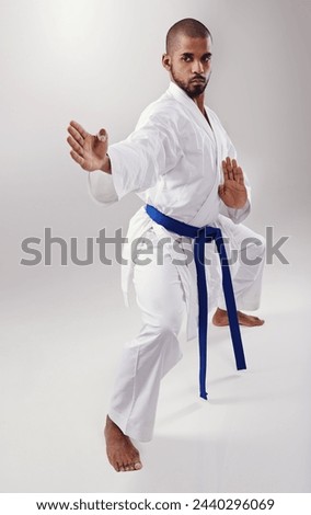 Studio, sport a d karate for black man, training and exercise for balance of body for physical health. White background, African male person and adult with uechi-ryu for self defense with hands