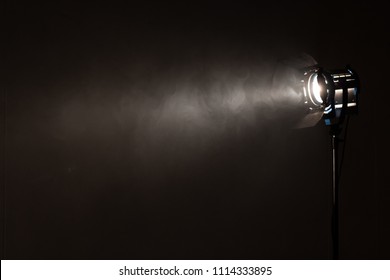 Studio Spotlight Using For Background Production Film . Silhouette Blurred Led Lights With Smoke In Dark Room . Electric Tools Set For Photography , Video Maker , Cinematography