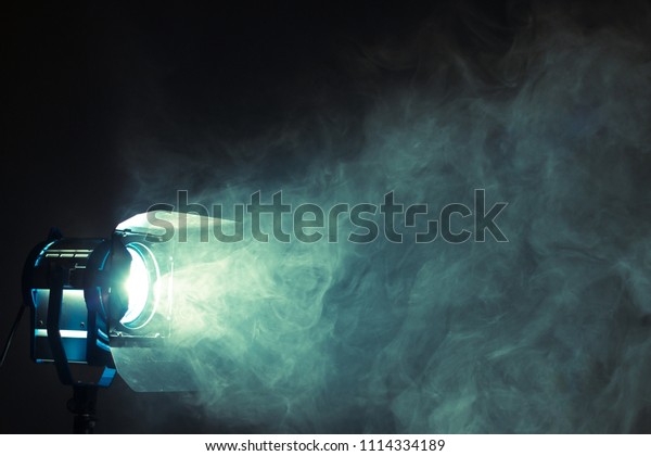 Studio\
spotlight using for background production film . silhouette blurred\
led lights with smoke in dark room . electric tools set for\
photography , video maker ,\
cinematography