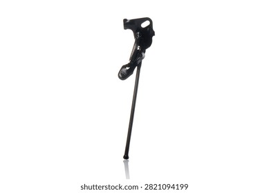 Studio three quarter perspective view of black steel bicycle kickstand featuring tension spring mechanism, axle mounting bracket, durable painted finish, and subtle bottom reflection on isolated white background showcasing cycling parking hardware.