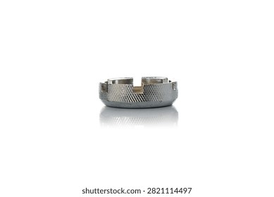 Studio three quarter perspective view of circular steel bicycle spoke wrench tool featuring knurled anti slip grip texture, multiple notch sizing slots, polished chrome finish, and soft bottom reflection on isolated white background showcasing cycling wheel repair maintenance equipment.