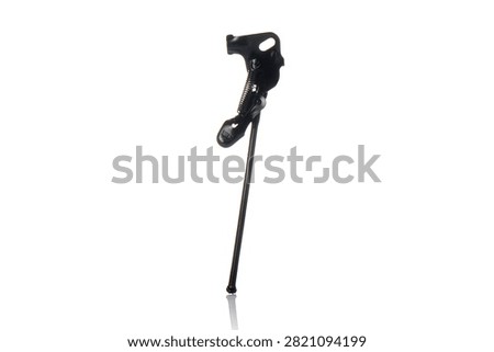 Studio three quarter perspective view of black steel bicycle kickstand featuring tension spring mechanism, axle mounting bracket, durable painted finish, and subtle bottom reflection on isolated white background showcasing cycling parking hardware.