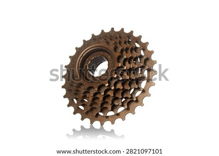 Studio three quarter perspective view of bronze multi speed bicycle freewheel cassette featuring steel gear sprockets, threaded hub core mechanism, polished metallic texture, and soft bottom reflection on isolated white background showcasing cycling drivetrain components.