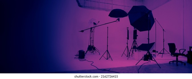 Studio Video Production Lighting Set. Behind The Scenes Shooting Production Set Up By Crew Team Camera And Equipment In Studio. Video Production Filming Or Commercial Movie Film Live Streaming Online.