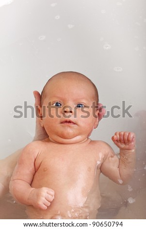 Similar – Image, Stock Photo Newborn in the bathtub held by her mother