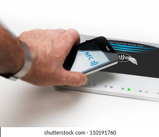 Studioshot Of Payment Action With A Mobile Phone In Front Of A NFC Terminal