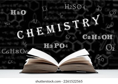 The study of the chemistry, composition and structure of matter. An open book, a textbook lies on the table. Chemical formulas and signs of chemical elements on a black background.