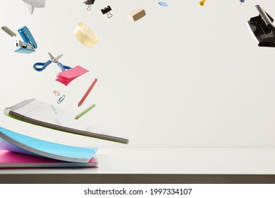 Study desk and chool supplies flying with white isolated background. Front view. Horizontal composition.