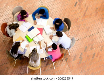 Study group with young people sitting in a round table